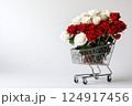 Shopping cart with red and white roses on white background and an empty space for text. Valentine's Day banner, template for advertisements of online shopping, flower delivery, weddings, floral gifts 124917456
