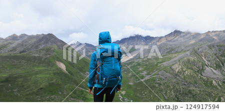 Hiking woman on high altitude mountain top 124917594