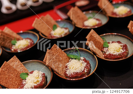 Exquisite beef tartare elegantly presented in ceramic bowls Exquisite beef tartare elegantly presented in ceramic bowls 124917706