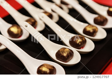 Elegant gourmet chocolate truffles with a touch of edible gold dust, 124917707