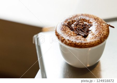Cup of hot milk chocolate mocha coffee on table by the window. Cup of hot milk chocolate mocha coffee on table by the window. 124918872