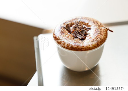 Cup of hot milk chocolate mocha coffee on table by the window. Cup of hot milk chocolate mocha coffee on table by the window. 124918874