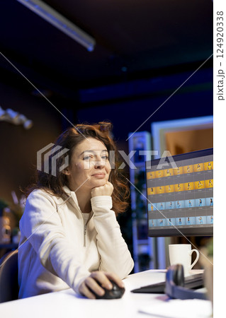 Portrait of happy photo editor color correcting photographs in creative studio while enjoying cup of coffee. Smiling photographer selecting best pictures for editorial content Portrait of happy photo editor color correcting photographs in creative studio while enjoying cup of coffee. Smiling photographer selecting best pictures for editorial content 124920338