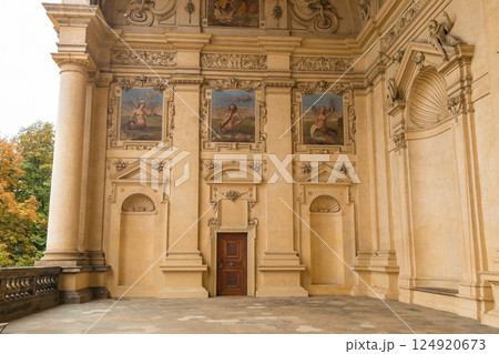 Low angle view of ornate Prague townhouses reaching skyward. Ground level perspective captures decorative facades, baroque details, and traditional architecture with dramatic upward effect. 124920673
