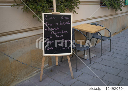 Cafe bar in the historical center of Krakow, Poland. Advertising billboard of the cafe on the main street. Cafe bar in the historical center of Krakow, Poland. Advertising billboard of the cafe on the main street. 124920704