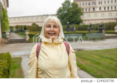 A female tourist walks around along a decorative alley decorated with many statues in a decorative park at Wallenstein Palace building in Prague in Czech Republic A female tourist walks around along a decorative alley decorated with many statues in a decorative park at Wallenstein Palace building in Prague in Czech Republic 124920736