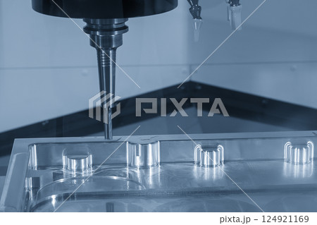 The CNC milling machine finish cut the aluminum parts by flat nose end mill tools in the light blue scene. 124921169