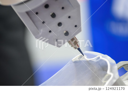The glue sealing process on automotive parts by robotic system. 124921170