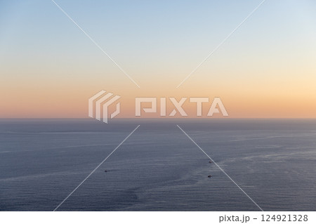 Peaceful view of the sea under a vivid sunrise sky Peaceful view of the sea under a vivid sunrise sky 124921328
