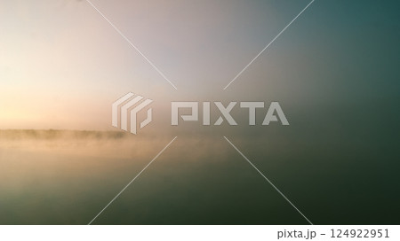 Abstract landscape, lake covered in fog at dawn Abstract landscape, lake covered in fog at dawn 124922951