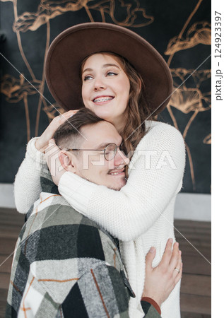 Smile with braces. Beautiful girl with braces on a date. Young people dancing, kissing and hugging, enjoying the meeting 124923397