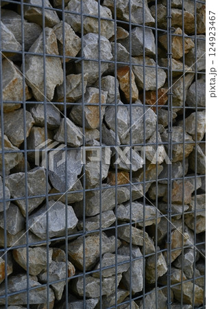 macro gray stone and iron mesh retaining wall, artificial retaining wall for crumbling hills	 124923467