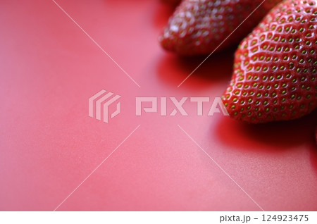 red juicy strawberries on a green background, summer photo background of strawberries as a background	 124923475