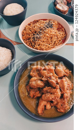 Yangnyeom chikin or korean fried chicken and ramyun noodles with rice served on a casual dining table 124924379