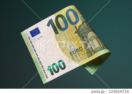 One hundred euro banknote on a dark green background. Studio shooting. One hundred euro banknote on a dark green background. Studio shooting. 124924719