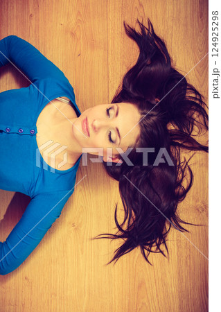 Woman lying on floor showing her pregnant belly 124925298
