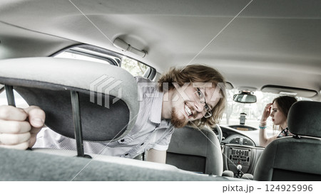 Happy man and woman in car Happy man and woman in car 124925996