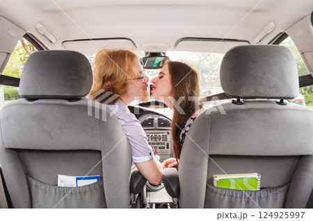 Man and woman kissing in car Man and woman kissing in car 124925997