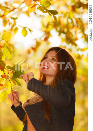 Attractive girl among trees and leaves Attractive girl among trees and leaves 124926063