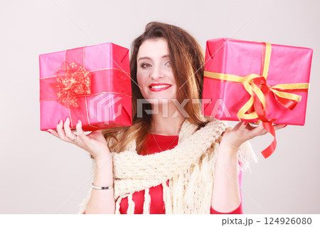 Woman holds red christmas gift boxes 124926080