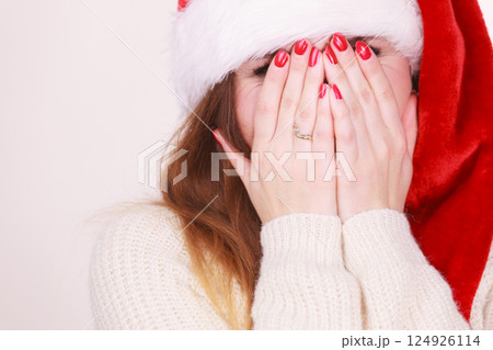 Woman wearing santa claus hat Woman wearing santa claus hat 124926114