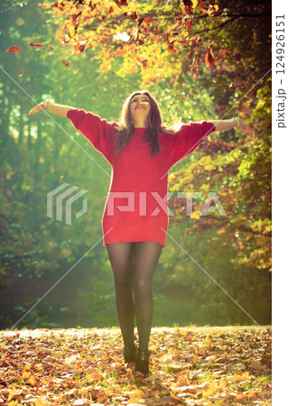 Girl tossing up leaves. Girl tossing up leaves. 124926151
