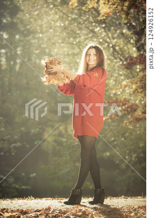 Young girl with golden leaves. Young girl with golden leaves. 124926152