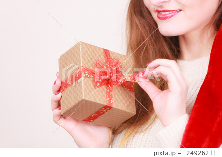 Woman opening gift box. Christmas time Woman opening gift box. Christmas time 124926211