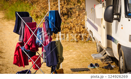 Clothes hanging to dry outdoors by camping car. Caravan vacation. 124926269