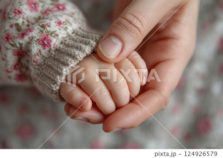 Tender moment of mother and baby hands together 124926579