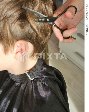 A young boy gets a new haircut  124926638
