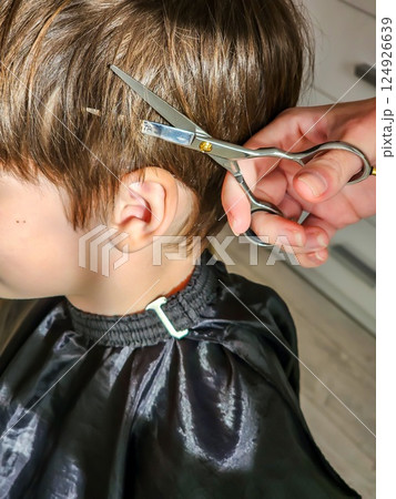 A young boy gets a new haircut  124926639