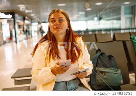 Traveler sad and unhappy woman at the airport with canceled flight 124926753