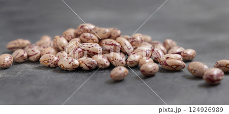 Pile of dried pinto beans on gray closeup. Traditional Latin American legumes, vegetarian food 124926989