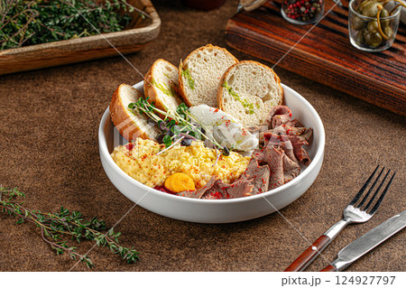 Portion of with scrambled eggs and pastrami Portion of with scrambled eggs and pastrami 124927797