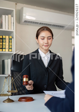Lawyer presenting a legal contract to a client, emphasizing professionalism in the office 124928227