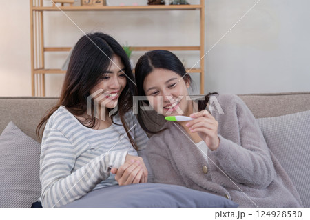 Lesbian couple celebrating ivf journey home setting lifestyle intimate environment joyful concept 124928530