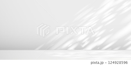 Glare from the sun's rays on the wall. Blurred shadows from leaves and plants in the room. Soft overlay of natural light. Abstract background for product presentation.Natural light layout. 124928596