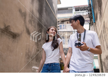 Couple traveling together urban alley lively environment romantic viewpoint adventure concept Couple traveling together urban alley lively environment romantic viewpoint adventure concept 124928639