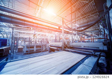 Production line of the wooden floor factory. CNC automatic woodworking machine. Production line of the wooden floor factory. CNC automatic woodworking machine. 124928824