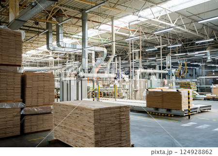 Production line of the wooden floor factory. CNC automatic woodworking machine. Production line of the wooden floor factory. CNC automatic woodworking machine. 124928862