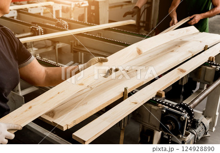 Production line of the wooden floor factory. CNC automatic woodworking machine. Production line of the wooden floor factory. CNC automatic woodworking machine. 124928890