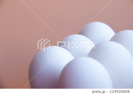 White Eggs arranged against Soft Pink backdrop, creating minimalist and modern aesthetic. Smooth, round shapes and pastel tones offer serene visual appeal, ideal photo for contemporary design themes White Eggs arranged against Soft Pink backdrop, creating minimalist and modern aesthetic. Smooth, round shapes and pastel tones offer serene visual appeal, ideal photo for contemporary design themes 124930008