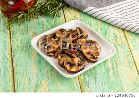 Tasty hot grilled champignon mushrooms 124930753