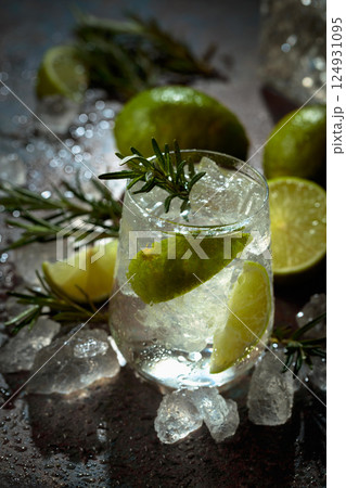 Gin and tonic cocktail made with dry gin, tonic water, lime, and ice. 124931095