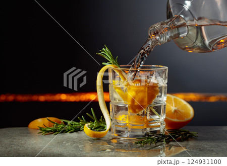 Refreshing gin-tonic cocktail with lemon and rosemary. Refreshing gin-tonic cocktail with lemon and rosemary. 124931100