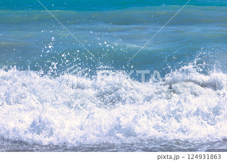 Nerja town, a resort of The Costa del Sol seaside region in Andalusia in the south of Spain. Ocean waves crashing on the shore, creating a frothy whitecap. 124931863