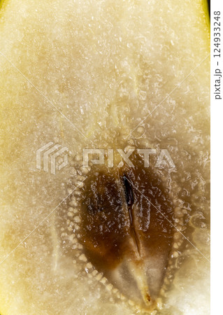 ripe green pear, the pulp inside of which has begun to rot, part of the rotted inside of a ripe pear 124933248