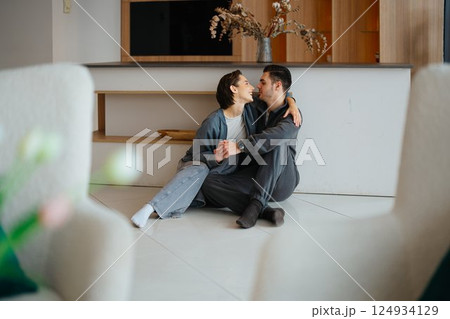 Cozy couple enjoying quality time together at home in a modern living space 124934129