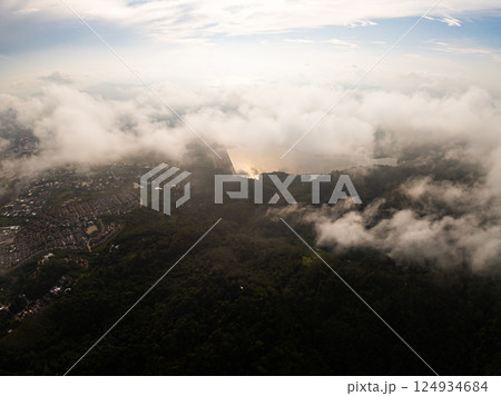 Aerial view drone shot of mountain tropical rainforest,Bird eye view image over the clouds Amazing nature background with clouds and mountain peaks 124934684